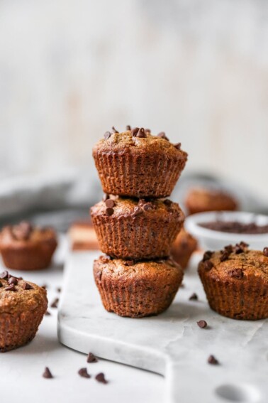 Stack of three chocolate chip almond flour muffins.