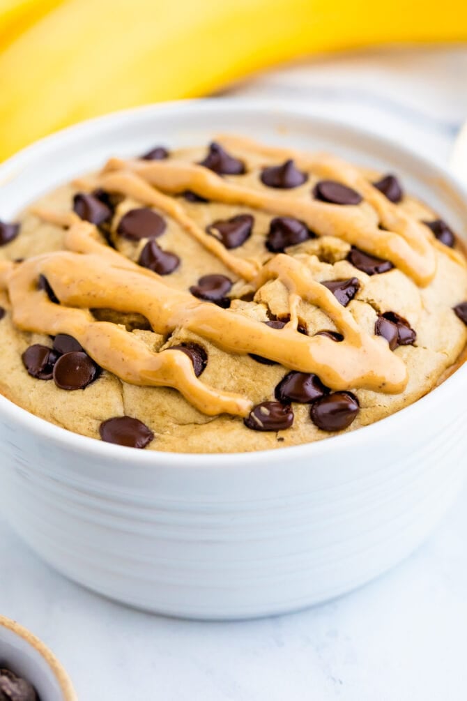 Bowl of blended baked oatmeal topped with peanut butter and chocolate chips.