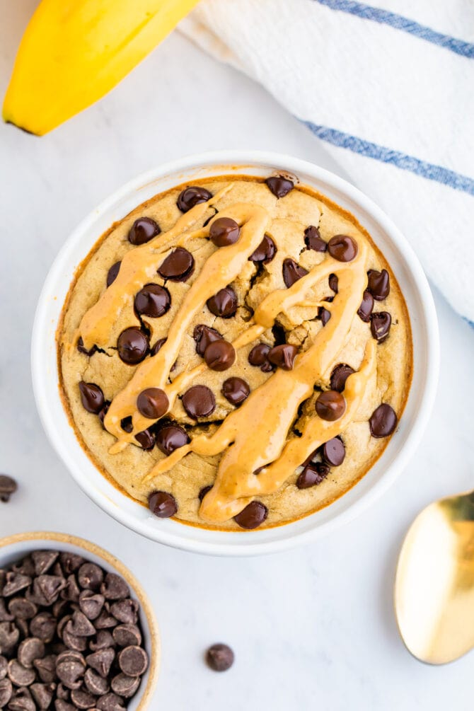 Bowl of blended baked oats topped with peanut butter and chocolate chips.