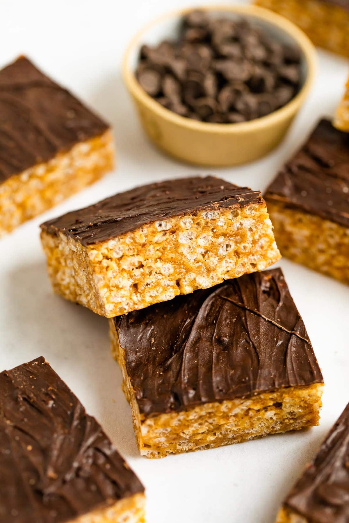 Two rice krispie treats topped with a layer of chocolate.