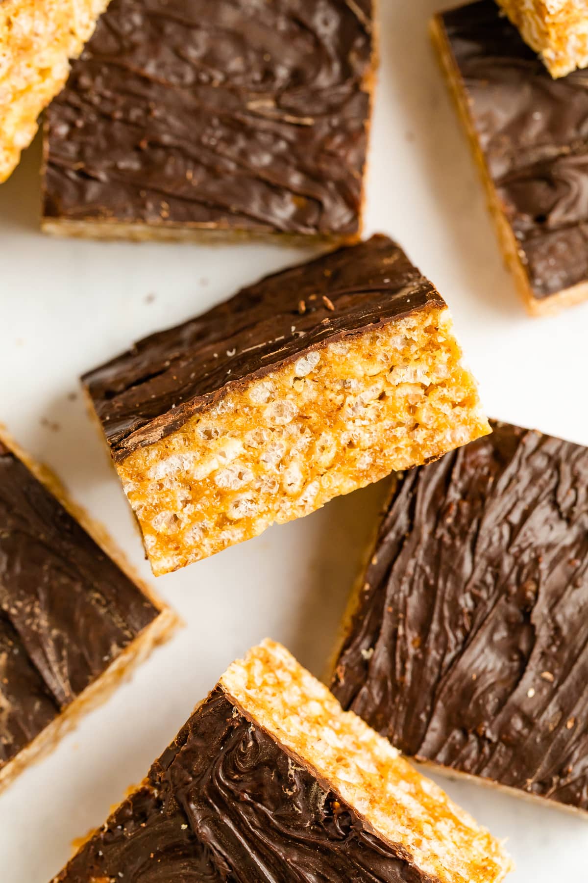 Close up photo of rice krispie treats topped with chocolate.