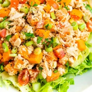 Close up photo of sweet potato tuna salad served on a bed of lettuce.