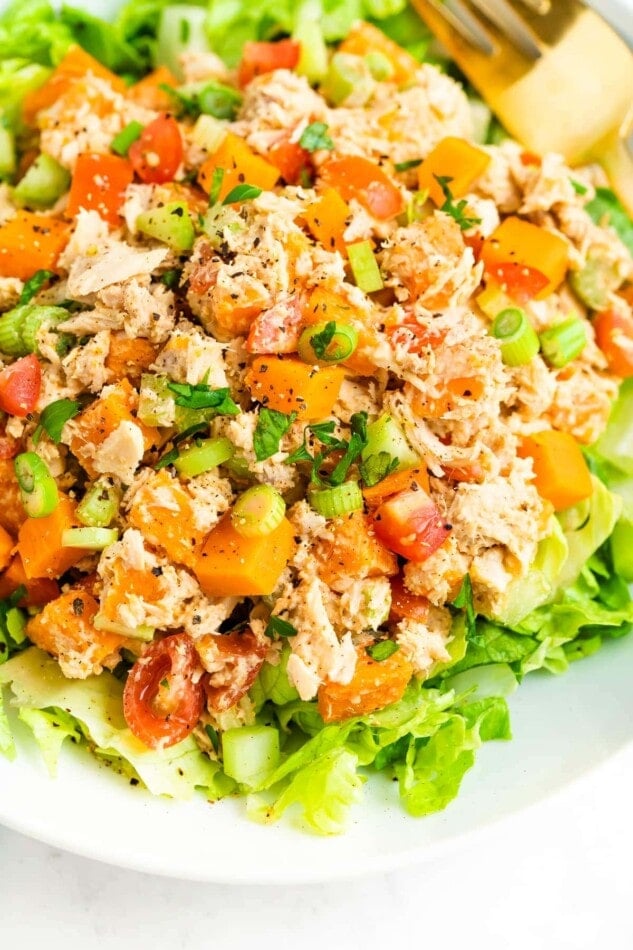 Close up photo of sweet potato tuna salad served on a bed of lettuce.