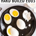 Plate with peeled and sliced hard boiled eggs.