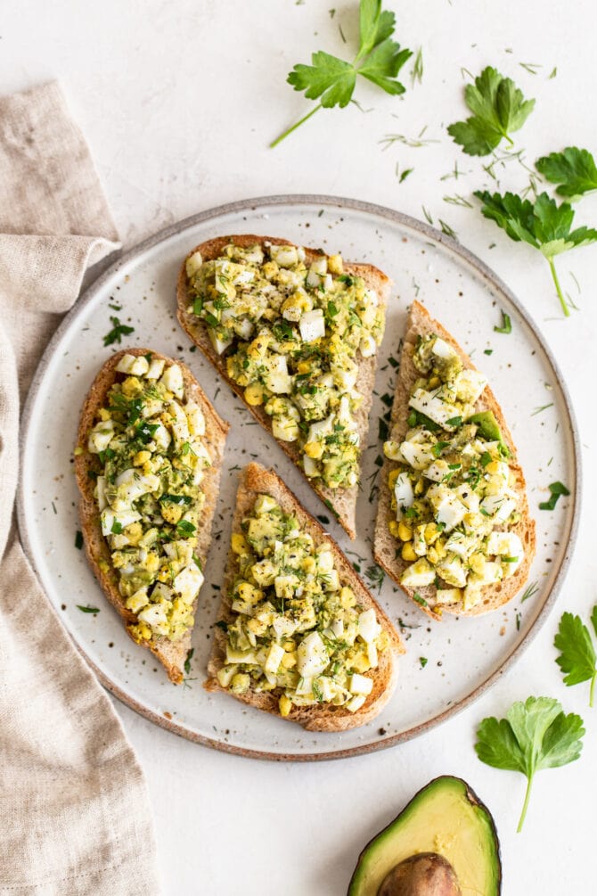 Avocado egg salad on four slices of toast.