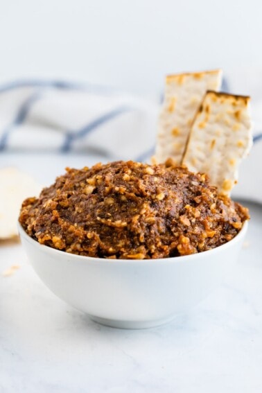 Bowl of charoset with a couple motzoh crackers.