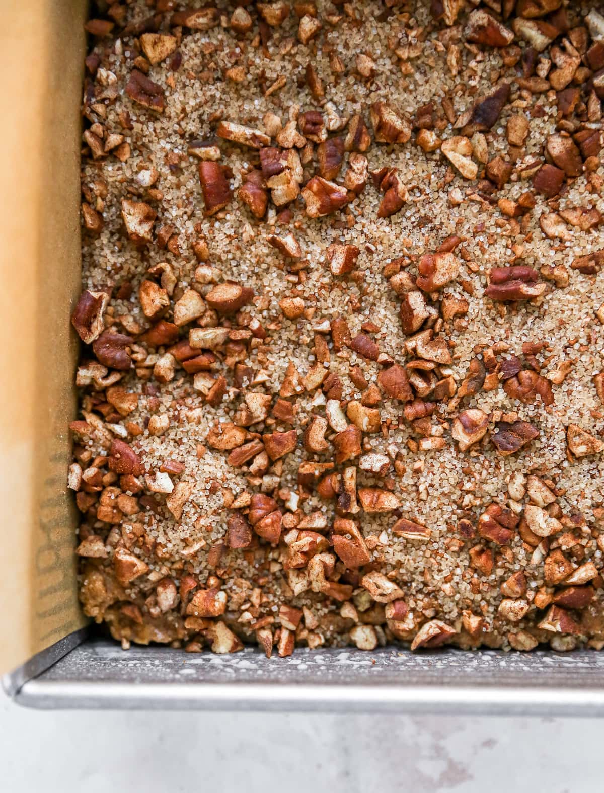 Coffee cake with crumble topping in a cake pan.