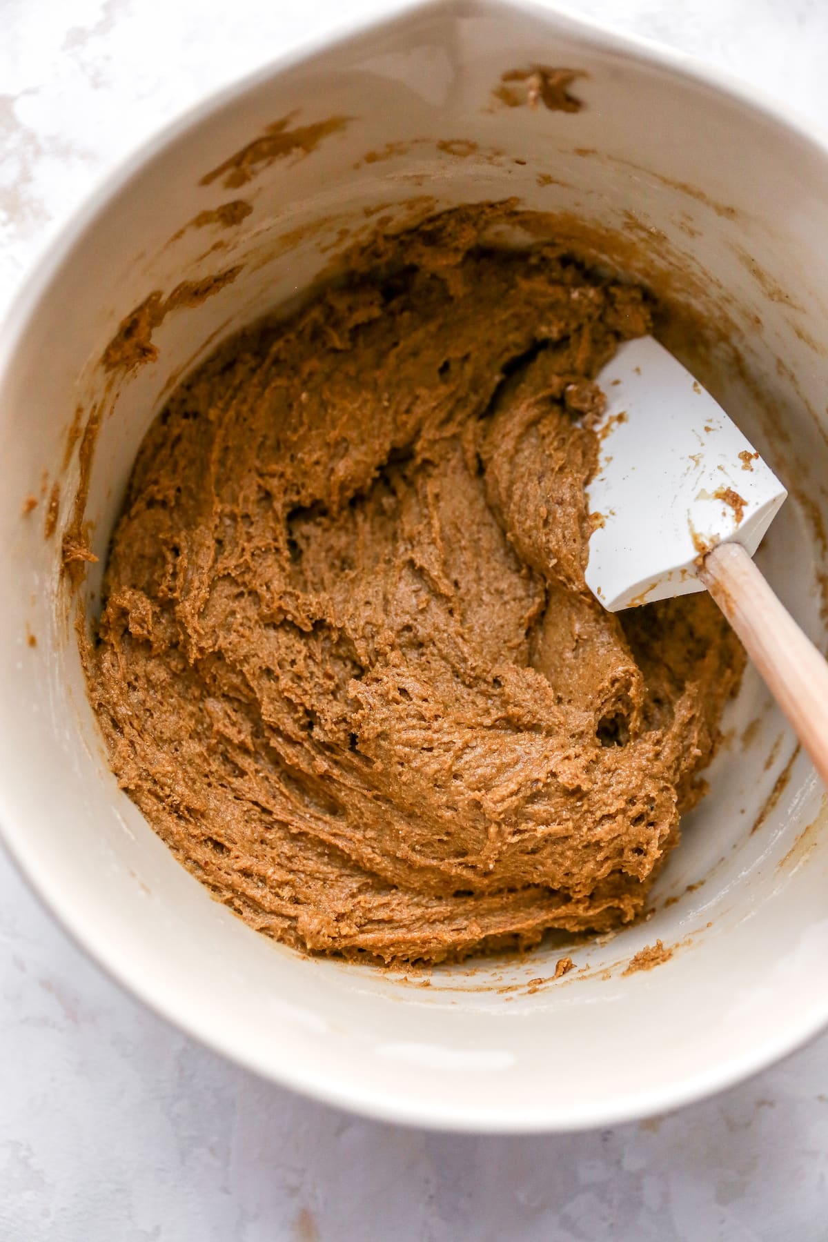 Mixing bowl of coffee cake batter with a spatula.