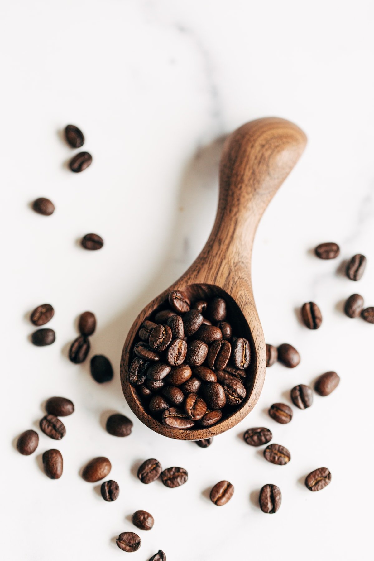 Wooden spoon with coffee beans.