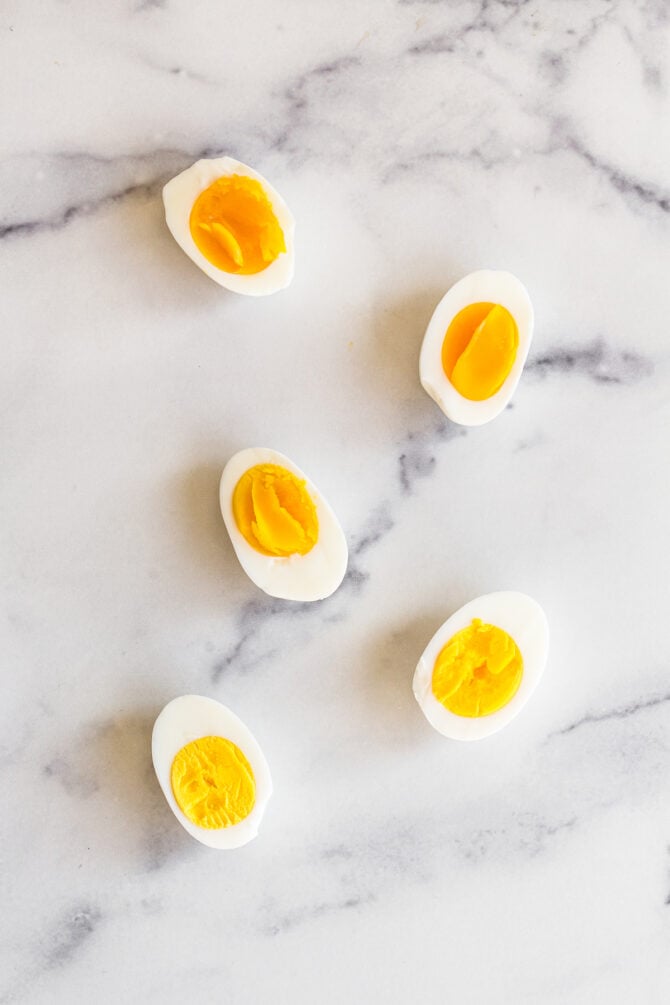 Halves of hard boiled eggs with different yolk textures.