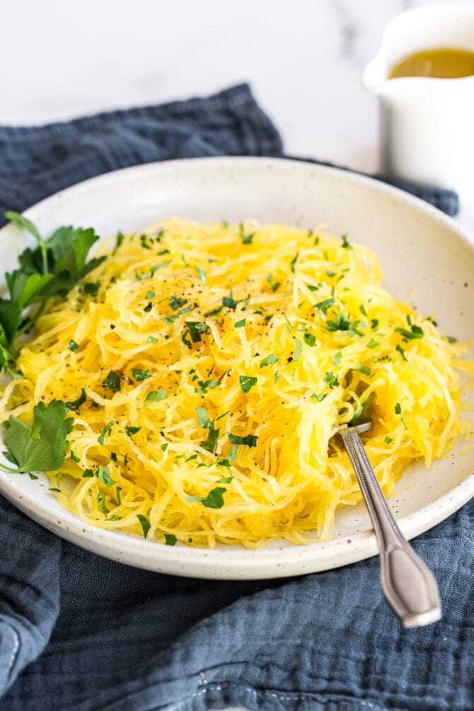 Plate of spaghetti squash topped with parsley.