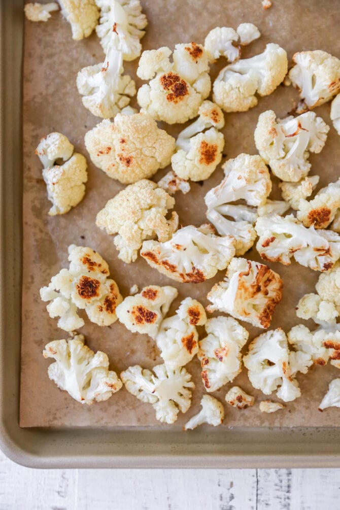 Roasted cauliflower on a sheet pan.