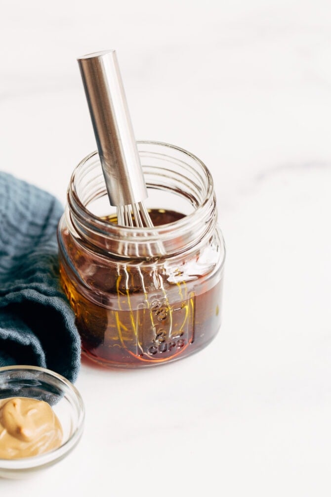 Whisk in a jar of olive oil and red wine vinegar.