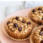 Three chocolate chip baked oatmeal cups on a plate.