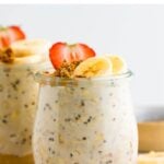 Two jars of overnight oats. The bottom as peanut butter and it's topped with fruit and granola.