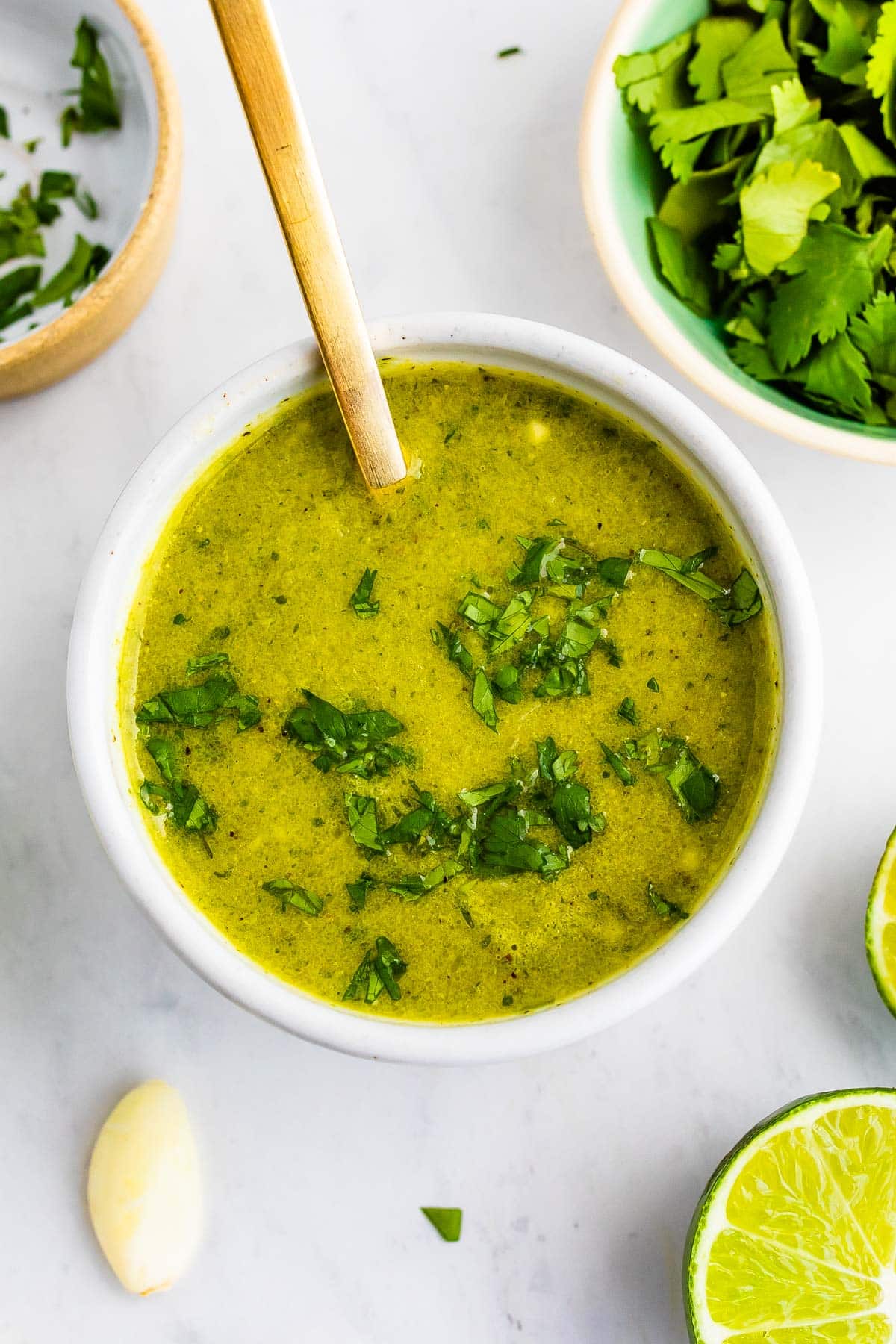 Bowl of cilantro lime dressing with a spoon.