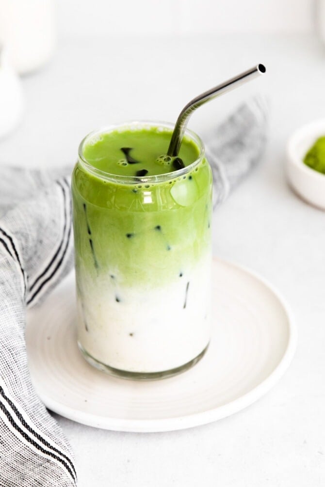 Iced Matcha Latte with a metal straw.