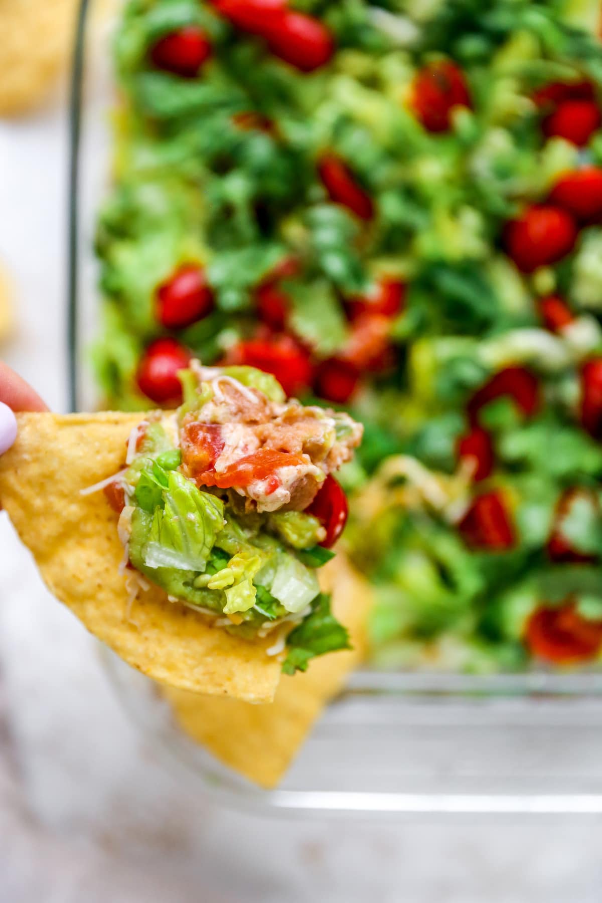 Tortilla chip with Mexican layer dip.