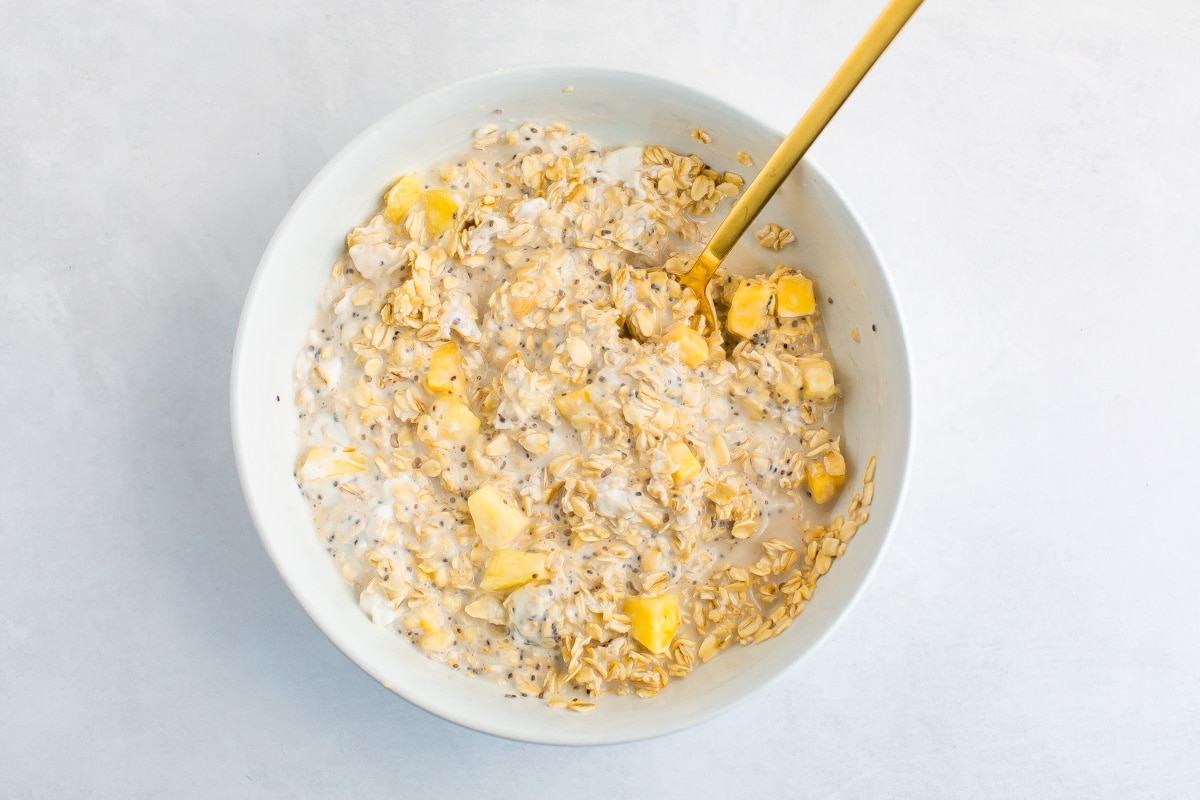 Mixed tropical overnight oats in a bowl.