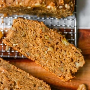 Slice of vegan banana bread on a cooling rack.