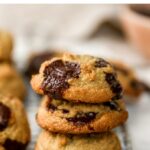 Stack of three almond flour chocolate chip cookies.