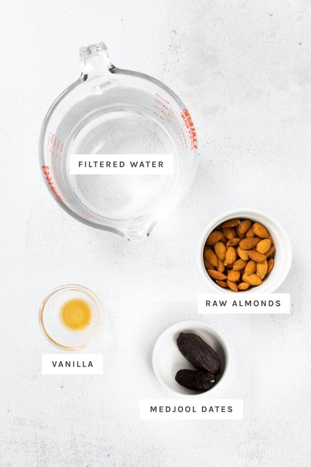 Water, almonds, vanilla and medjool dates measured out to make almond milk.