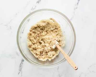 Almond cracker dough in a mixing bowl with a spatula.