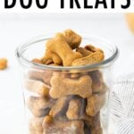 Glass jar full of peanut butter dog treats in the shape of bones.