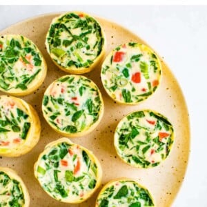 Plate with spinach and red pepper egg white bites.