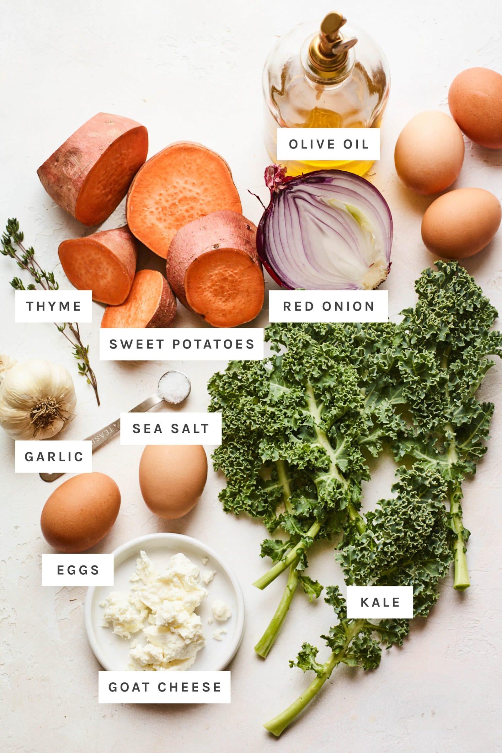 Ingredients to make a sweet potato kale frittata on a table measured out.