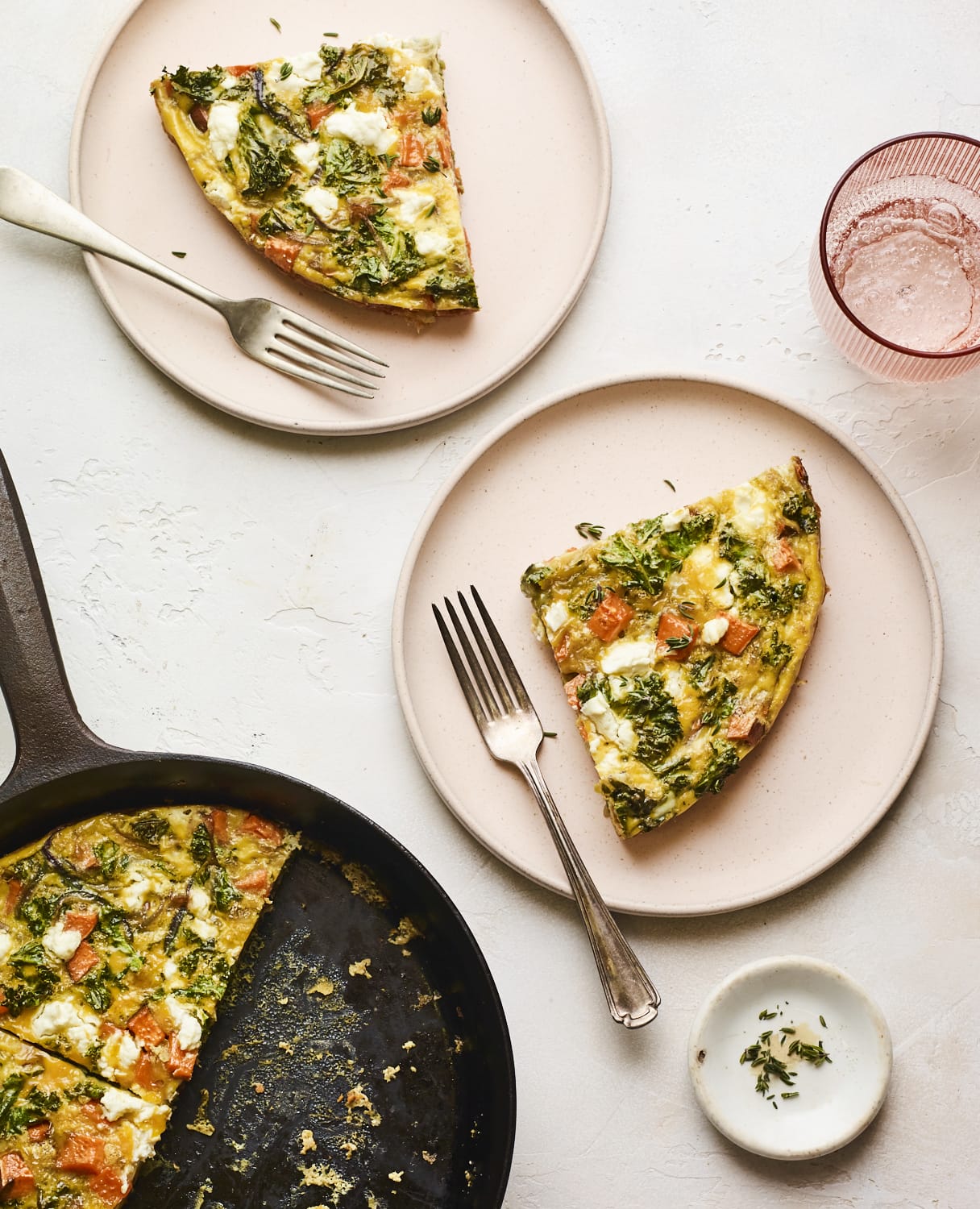 Slices of sweet potato kale frittata on two plates.