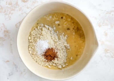 Mixing bowl with ingredients to make almond flour pancakes before being whisked together.