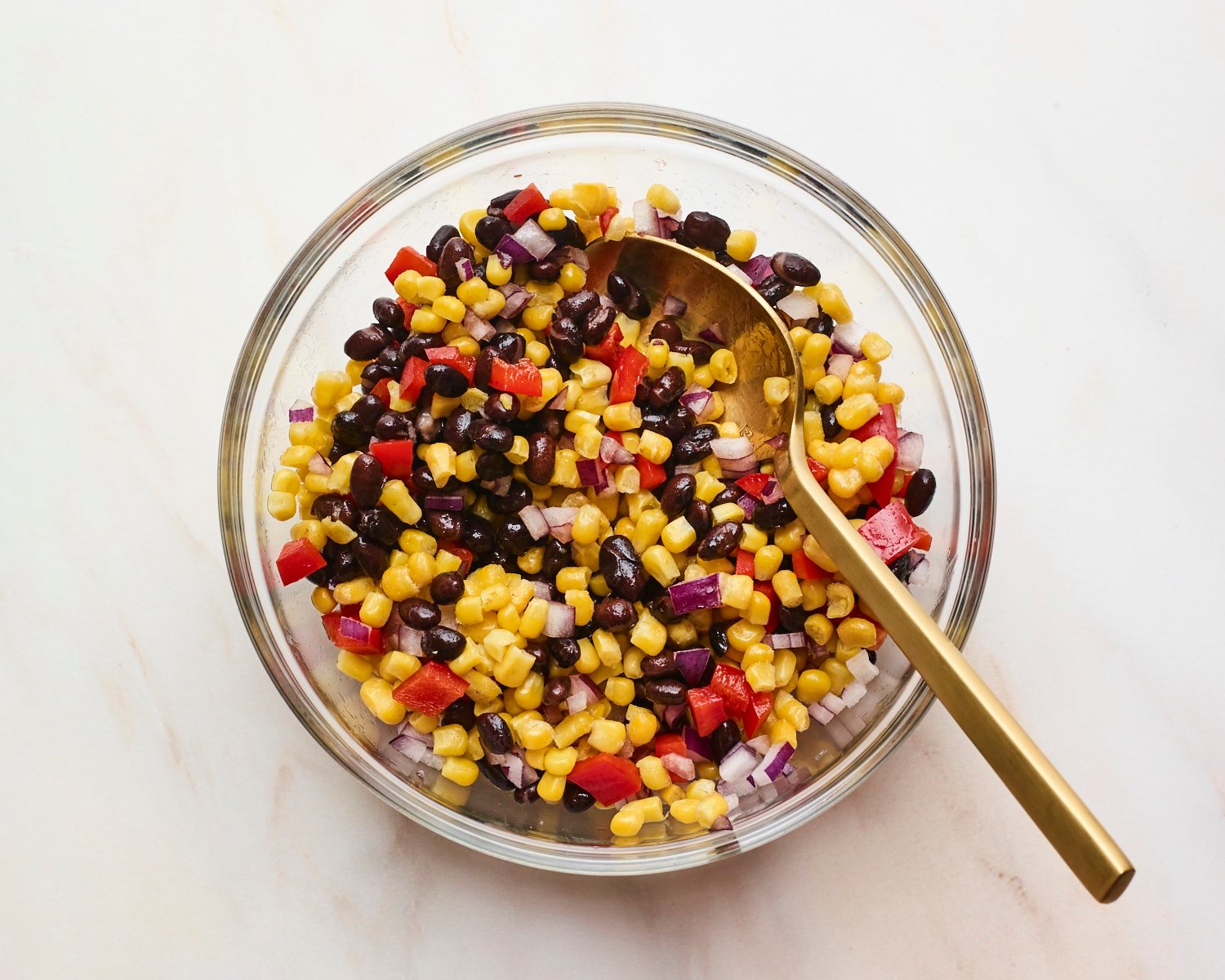 Mixing bowl with black bean and corn salad.