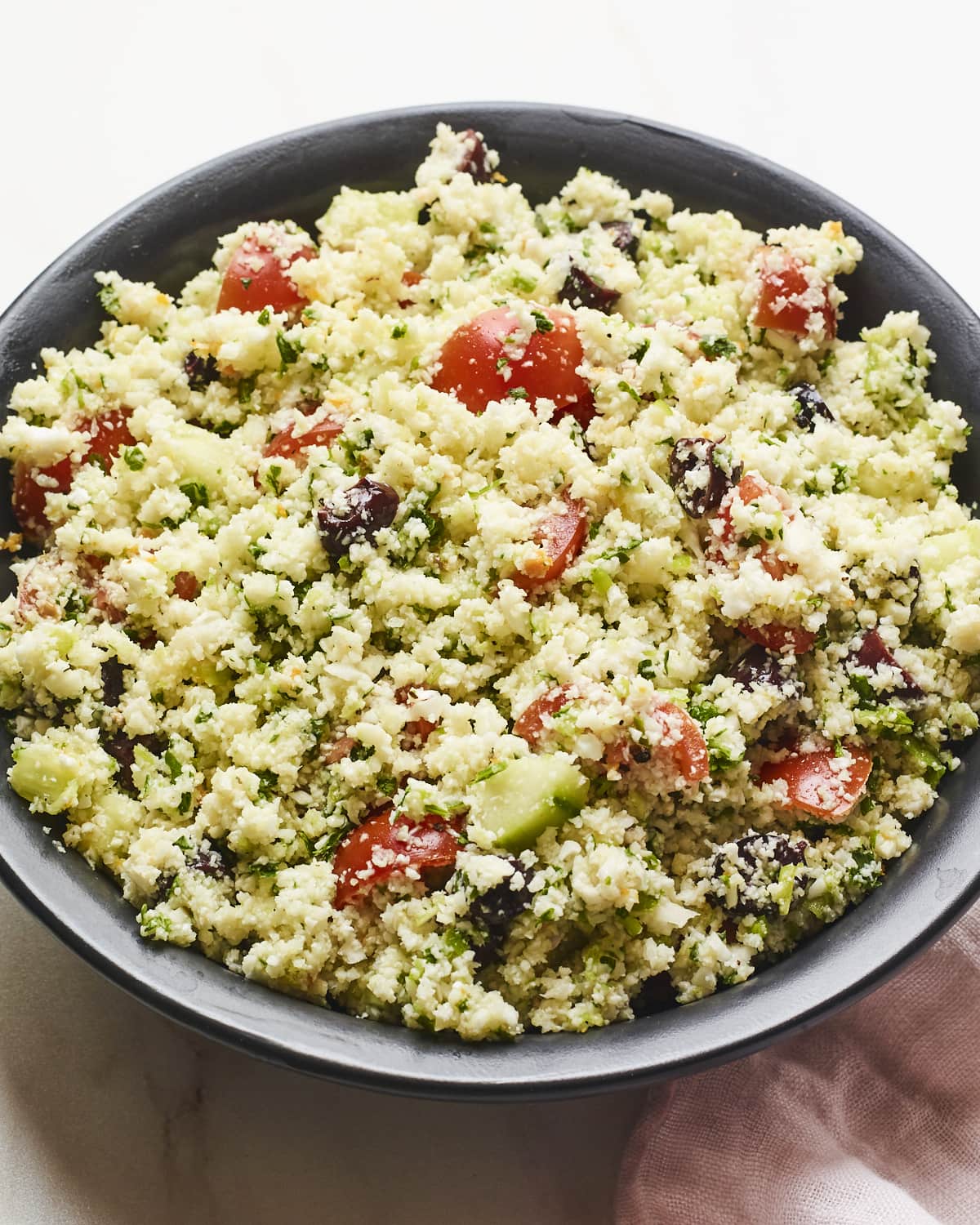 Serving bowl full of cauliflower tabbouleh.