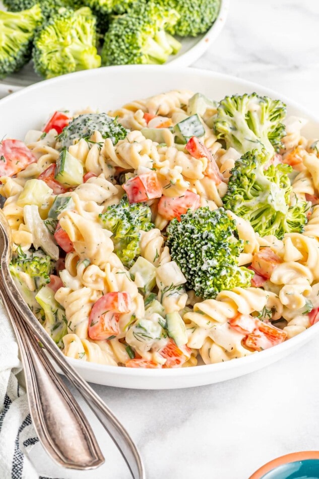 Serving bowl with ranch pasta salad with broccoli, peppers and cucumber.