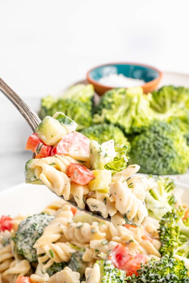 Fork taking a bite of ranch pasta salad.