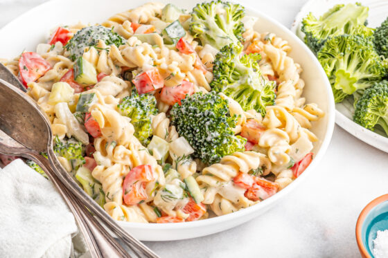 Serving bowl with ranch pasta salad with broccoli, peppers and cucumber.