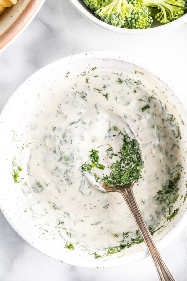 Greek yogurt ranch in a bowl with a spoon.