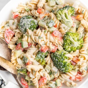 Serving bowl with ranch pasta salad with broccoli, peppers and cucumber.