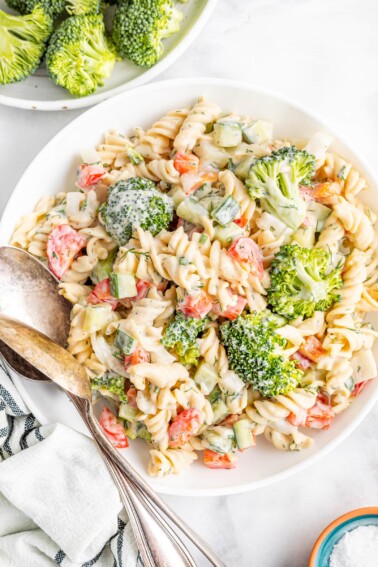 Serving bowl with ranch pasta salad with broccoli, peppers and cucumber.