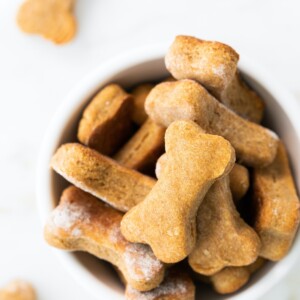 Bowl of bone-shaped homemade dog treats.