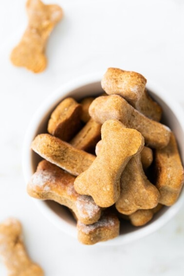 Bowl of bone-shaped homemade dog treats.