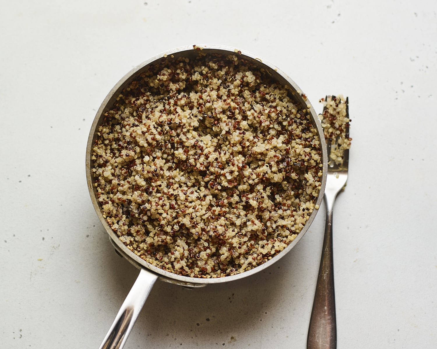 Pot with cooked quinoa.