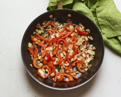Pan with sautéed onion and bell pepper.