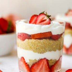 Strawberry, yogurt and quinoa parfait, layered in a glass.