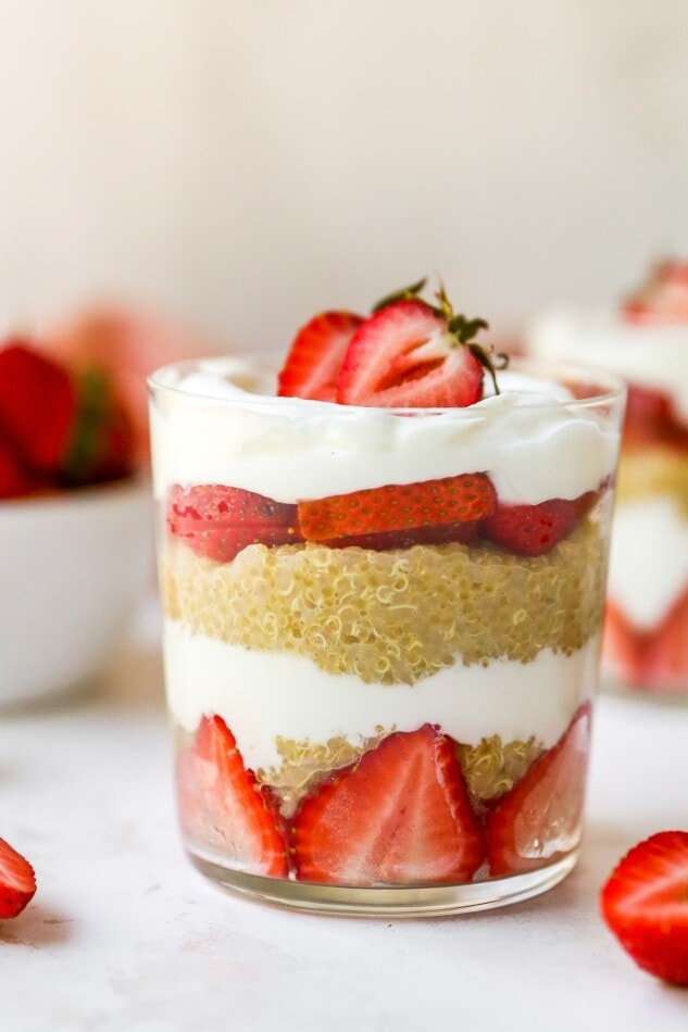 Strawberry, yogurt and quinoa parfait, layered in a glass.