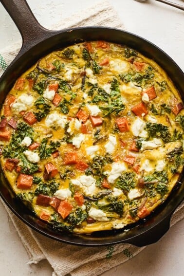 Sweet potato kale goat cheese frittata in a skillet.