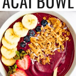 Acai bowl topped with banana, blueberries, strawberries, granola and peanut butter.