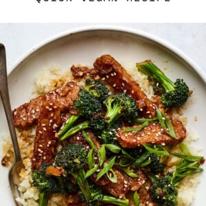 Plate of teriyaki tempeh and broccoli served over rice.