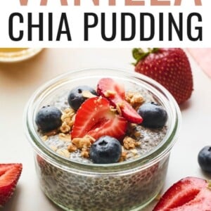 Jar of chia pudding topped with berries and granola.